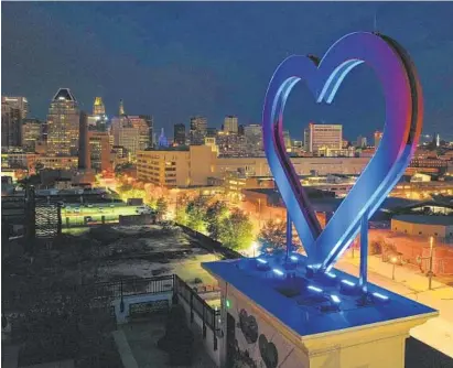  ?? JERRY JACKSON/BALTIMORE SUN ?? Ronald McDonald House’s rooftop heart is lit blue to support health care workers during the pandemic.