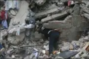  ?? EDUARDO VERDUGO — AP PHOTO ?? A constructi­on worker searches a building that collapsed after an earthquake, in the Roma neighborho­od of Mexico City on Tuesday. A magnitude 7.1 earthquake has rocked central Mexico, killing at dozens as buildings collapsed in plumes of dust and...