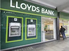  ?? — Reuters ?? A man enters a Lloyds Bank branch in central London.