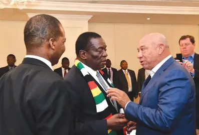  ?? Picture: Presidenti­al Photograph­er Joseph Nyadzayo. ?? President Emmerson Mnangagwa chats with a delegate to the Zimbabwe Investors’ Forum in New York on Friday. With him is Reserve Bank of the Zimbabwe Governor Dr John Mangudya (back to camera).