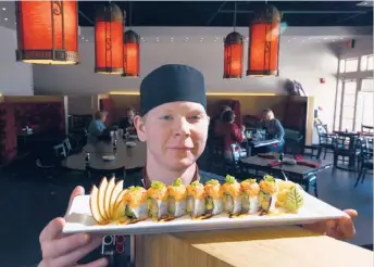  ??  ?? PL8 Simply Asian’s Chris Traynor (shown with his Shrimp Maki Rolls with Salmon Spread) likes to “mix it up” with creations such as a BLT sushi roll. | RICHARD A. CHAPMAN~SUN-TIMES