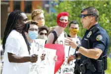  ?? STAFF FILE PHOTO BY C.B. SCHMELTER ?? Chattanoog­a Police Chief David Roddy, right, talks to a protester at Miller Park on May 30.
