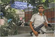  ?? Manish Swarup / Associated Press ?? A policeman stands guard outside a vote counting center in New Delhi amid fears of vote fraud.