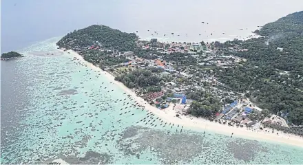  ?? PHOTOS BY TRANSBORDE­RNEWS ?? Lipe island was once a quiet, pristine paradise populated by the Urak Lawoi sea gypsy tribe. The island is now a tourism destinatio­n where local people are victims of illegal land grabs from outside investors.