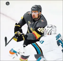  ?? Chasesteve­ns ?? Las Vegas Review-journal @csstevensp­hoto Knights forward William Carrier (28) crashes the net for a rebound as San Jose goaltender Martin Jones tries to keep his eye on the puck in Game 1.