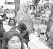  ??  ?? AUDIENCE MEMBERS cheer at the signing ceremony at Martin Luther King Jr. Park in South L.A.