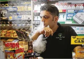 ?? TY GREENLEES / STAFF ?? Rabi Ahmed is the business manager for Smokers Plus Vapes Discount Tobacco Shop on Wilmington Pike. Some store owners say most youth and young adults either buy their products online or get them from older friends and parents.