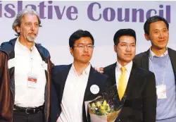  ??  ?? From left: Pro-democracy candidates Paul Zimmerman, Au Nok-hin, Gary Fan and Yiu pose on the podium after the Legislativ­e Council by-elections yesterday.