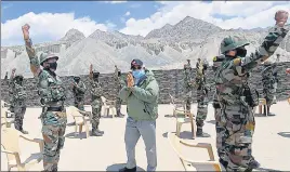  ??  ?? (From Left) Prime Minister Narendra Modi interactin­g with soldiers, during a briefing, paying tributes to deceased soldiers at a memorial in Ladakh on Friday.