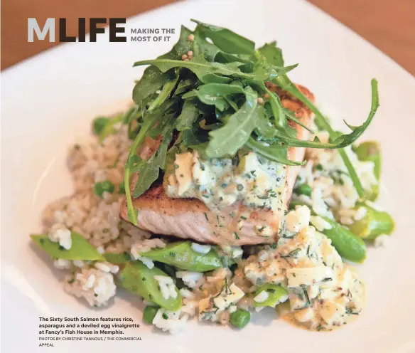  ?? PHOTOS BY CHRISTINE TANNOUS / THE COMMERCIAL APPEAL ?? The Sixty South Salmon features rice, asparagus and a deviled egg vinaigrett­e at Fancy’s Fish House in Memphis.