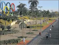  ?? Picture: REUTERS ?? People exercise next to the Olympic rings placed at the Madureira Park, ahead of the 2016 Olympics, in Rio de Janeiro in May 2015.