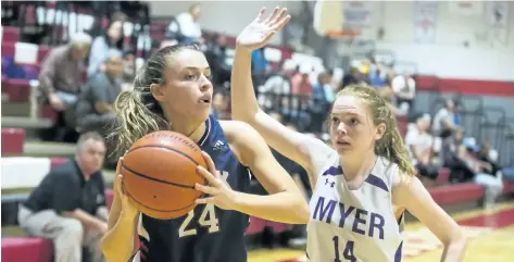  ?? JULIE JOCSAK/STANDARD STAFF ?? Alex Hebert of the Jean Vanier Lynx tries to keep the ball away from Rosie Tait of the A.N. Myer Marauders in the Standard Girls Basketball Tournament at Governor Simcoe in St. Catharines on Wednesday.