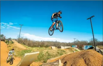  ?? NWA Democrat-Gazette File Photo/BEN GOFF • @NWABENGOFF ?? Owen Polumbo (left) and Carson Brantley, both 13 and from Rogers, catch air on the expert line at The Railyard Bike Park in Rogers.