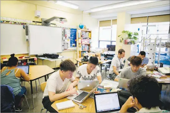  ?? PHOTOS BY SAM HODGSON / THE NEW YORK TIMES ?? Students at Flushing Internatio­nal High School work on projects Aug. 4 during the school’s summer program in New York. Mastery-based learning allows students to learn at their own pace.