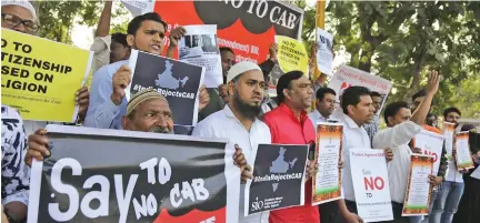  ?? Photo: AP ?? Indians holds placards and shouts slogans during a protest against Citizenshi­p Amendment Bill (CAB) in Ahmadabad, India on December 9, 2019.