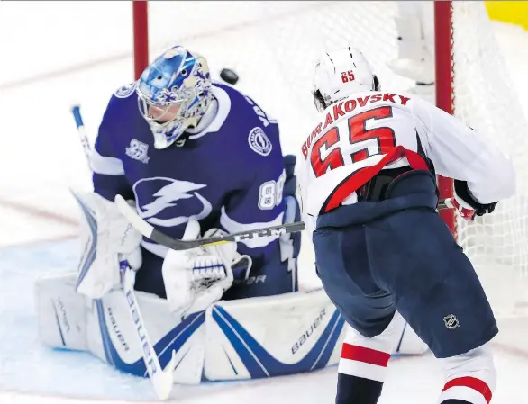  ?? MIKE CARLSON/GETTY IMAGES ?? Andre Burakovsky scores on Lightning goalie Andrei Vasilevski­y in the Washington Capitals’ 4-0 Eastern final Game 7 win on Wednesday in Tampa, Fla.