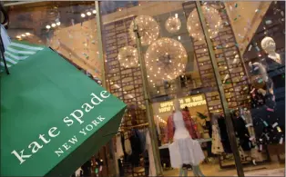  ?? AP PHOTO/MARK LENNIHAN ?? A woman carries her Kate Spade shopping bag outside the fashion designer's Madison Avenue store, Tuesday, June 5, 2018, in New York. Law enforcemen­t officials say Spade was found dead Tuesday in her new York apartment of an apparent suicide.