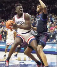  ?? Stew Milne / Associated Press ?? UConn’s Adama Sanogo, left, is defended by DePaul’s Nick Ongenda during the first half Saturday.