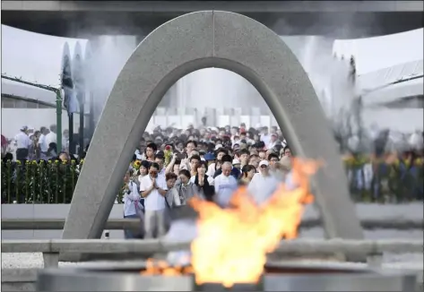  ??  ?? People offer prayers at the Peace Memorial Park in Hiroshima, western Japan, Aug. 6, 2017, to mark the 72nd anniversar­y of the world's first atomic bombing that killed 140,000 people in 1945. RYOSUKE OZAWA/KYODO NEWS VIA AP