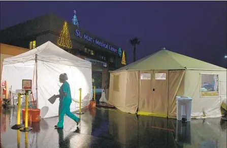  ?? Francine Orr Los Angeles Times ?? FEW PATIENTS were arriving on a cold and rainy Christmas Eve at Providence St. Mary Medical Center in Apple Valley.