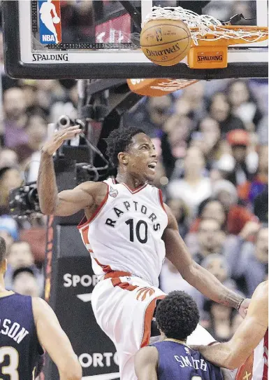  ?? NATHAN deNeTTe / THe CANAdIAN PreSS ?? Raptors guard DeMar DeRozan was on the finishing end of an alley-oop, courtesy of teammate Kyle Lowry in the second half of Friday’s victory over the New Orleans Pelicans.