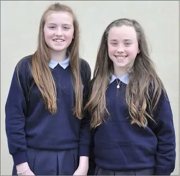  ??  ?? Meabh Fee and Clara McGahon of St Oliver Plunkett NS on their Confirmati­on Day in St Furseys Church Haggardsto­wn