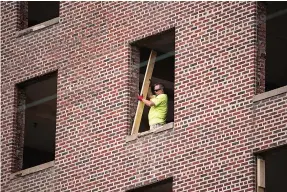  ?? Staff photo by Danielle Dupree ?? ■ Work on the Hotel Grim continues Tuesday afternoon in downtown Texarkana despite the COVID-19 pandemic. Most of the subcontrac­tors are able to safely distance themselves from one another, said Tim Minson, Cohen-Esrey Developmen­t Group project manager. “No one’s backed down,” Minson said. “The employees have to work to feed their families.”