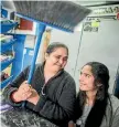  ??  ?? Dairy owner Bharati Gandhi and daughter Divya Gandhi, 17, at the Devyish Superette in Kilbirnie.