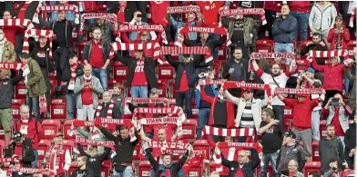  ?? — AP ?? Keeping a safe distance: Union Berlin supporters cheering on their team during a friendly against second-division FC Nuremberg in Berlin.