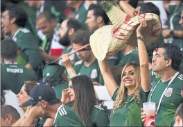  ?? MARTIN MEISSNER — THE ASSOCIATED PRESS ?? Mexico supporters celebrate following Wednesday’s loss after hearing the result of South Korea’s 2-0 upset win over Germany that allowed their team to advance at the World Cup.