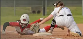  ?? (Special to the NWA Democrat-Gazette/Brian Sanderford) ?? Fort Smith Northside’s Cailin Massey (left) slides safely into third base before the tag by Fort Smith Southside’s Reese Robinson on Monday at Grizzly Field in Fort Smith. Northside won 5-2.