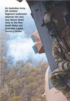  ??  ?? An Australian Army 5th Aviation Regiment loadmaster observes the area near Mount Ginini close to the New South Wales and Australian Capital Territory border.