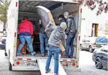  ?? [PHOTO PROVIDED] ?? Cody Taylor, the husband of Arbor Grove Elementary fifth-grade teacher Jamie Taylor, helps unload a mattress from a truck and carry it into a home being furnished.