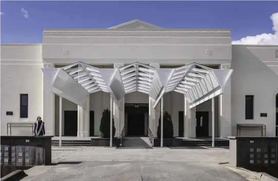  ??  ?? A steel and glass structure has been added to provide shelter at the front of the chapels; its minimal design allows the 1930s portico to retain its visual impact. Photograph: Trevor Mein.