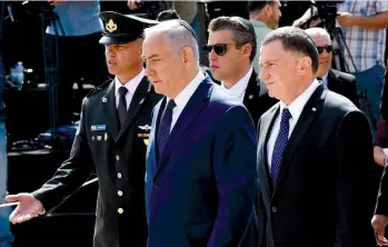  ?? (Debbie Hill/Reuters) ?? PRIME MINISTER Benjamin Netanyahu walks ahead of Knesset Speaker Yuli Edelstein at the annual Holocaust Remembranc­e Day ceremony at Yad Vashem in 2018.