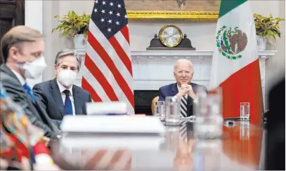  ?? Andrew Harnik The Associated Press ?? President Joe Biden, accompanie­d by national security adviser Jake Sullivan, left, and Secretary of State Antony Blinken, attends a virtual meeting Monday with Mexican President Andrés Manuel López Obrador in the Roosevelt Room.