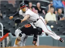  ?? Brett Davis ?? The Associated Press Dee Gordon arrives at third with a first-inning triple as Braves third baseman Rio Ruiz awaits a throw in the Marlins’ 6-5 loss Thursday.