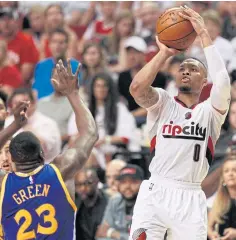  ?? EPA ?? Trail Blazers guard Damian Lillard shoots against Warriors forward Draymond Green.