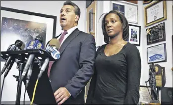  ?? AP ?? Attorney Scott Rynecki, left, and Kimberly Ballinger, the partner of Akai Gurley, announced a lawsuit last month against the city and New York police over Gurley’s death. Rynecki said Tuesday that Peter Liang, the officer who shot Gurley, has been...