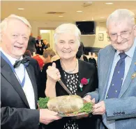  ??  ?? Address to the Haggis May Lobban with president John Mitchell, left, and past president Harvey Littlejohn