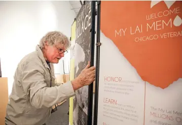  ?? GABRIELA CAMPOS/THE NEW MEXICAN ?? Artist Mac MacDevitt sets up panels Thursday for the My Lai Massacre Memorial Project at El Museo Cultural de Santa Fe. The three-day exhibit is free, but donations are welcome.