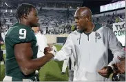  ?? AL GOLDIS — THE ASSOCIATED PRESS ?? Michigan State coach Mel Tucker, right, congratula­tes Kenneth Walker III following an Oct. 2game against Western Kentucky in East Lansing.