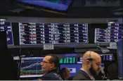  ?? SPENCER PLATT / GETTY IMAGES ?? Traders work on the floor of the New York Stock Exchange on Friday. The Labor Department said January’s spike in wages was a bit smaller than it originally thought. It made for a happy ninth anniversar­y for the current bull market.