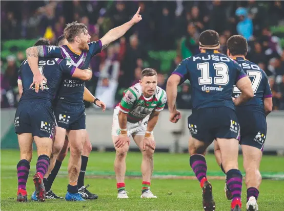  ?? SWEET KICK: Storm five- eighth Cameron Munster celebrates with teammates after kicking last night’s winning field goal against the Rabbitohs. ??