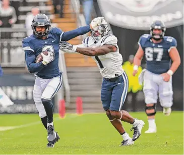  ?? Photo courtesy UConn athletics ?? UConn running back Cam Edwards carries the ball against Utah State Saturday at Rentschler Field.