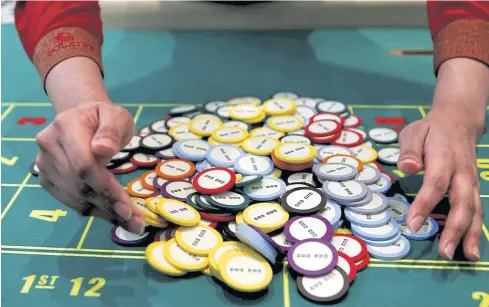  ?? REUTERS ?? A casino dealer collects chips at a roulette table in Pasay city, Metro Manila.