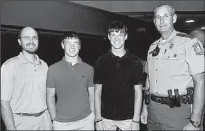  ??  ?? Darrin Farmer of Clinton with his sons, Drew and Travis,
and Cpl. Todd Smith of Saline County