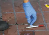  ?? Paul Chinn / The Chronicle ?? Michael Lopez, working for the Central Market Community Benefit District, picks up a needle from the debrisstre­wn sidewalk on Market Street.