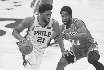  ?? BILL STREICHER/USA TODAY SPORTS ?? Philadelph­ia 76ers center Joel Embiid (21) drives against Boston Celtics forward Semi Ojeleye (37) on Wednesday in Philadelph­ia.