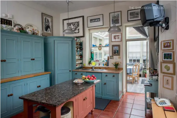  ??  ?? Top: Cabinets crafted by Jonathan Avery provide plenty of storage in the kitchen. Right: Artworks even adorn the kitchen walls.